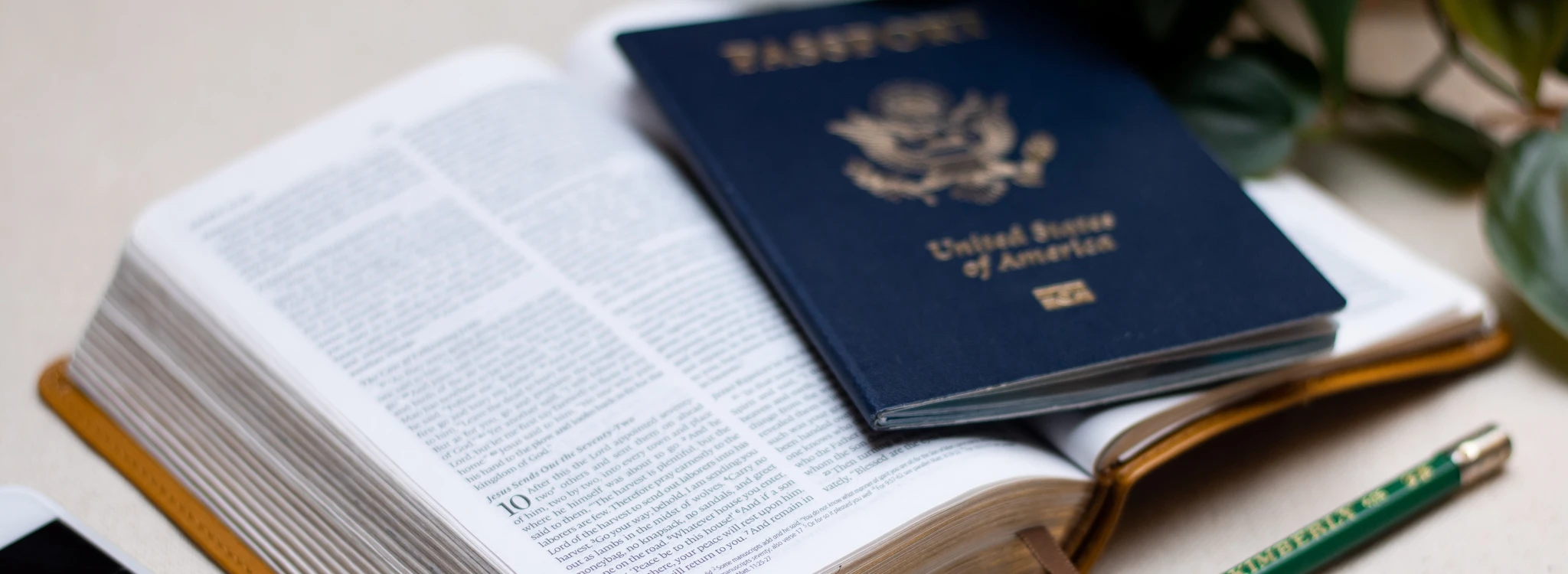 U.S. passport laying on a Bible open to Luke 10