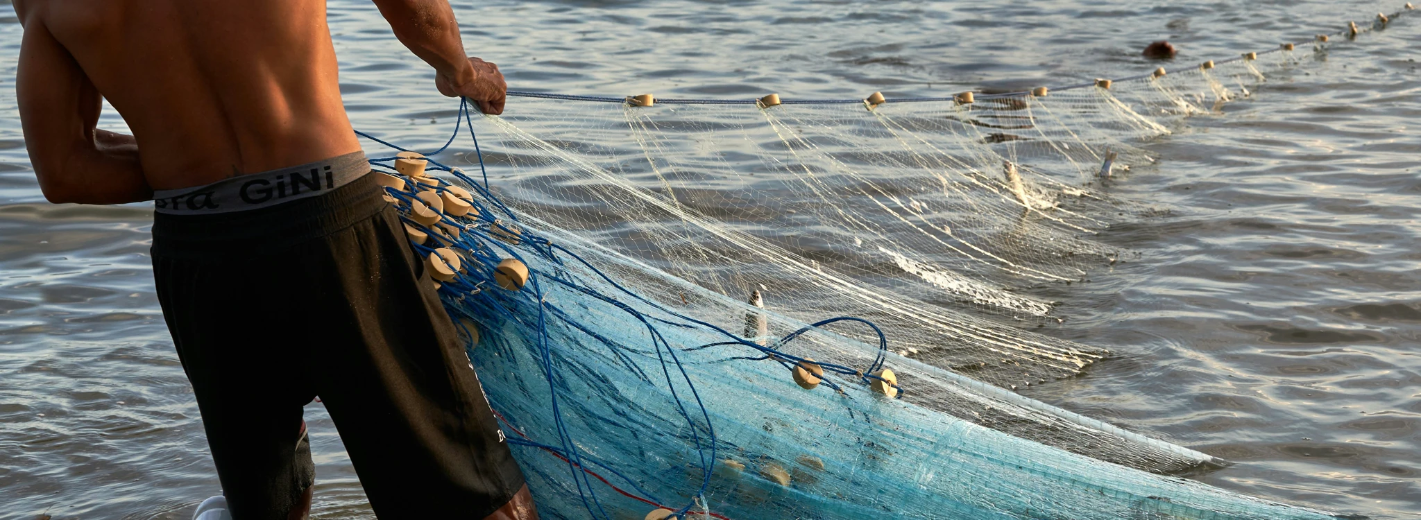 Fisherman hauling in a net