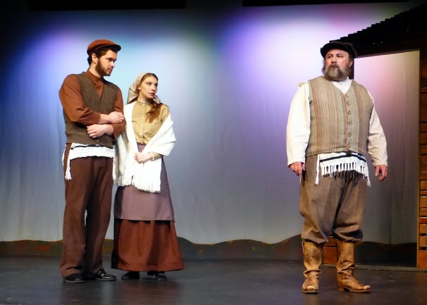 Tevye considers Motl's and Tzeitl's pledge in a stage production of Fiddler on the Roof